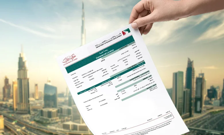 Hand holding a commercial license document over a city skyline background